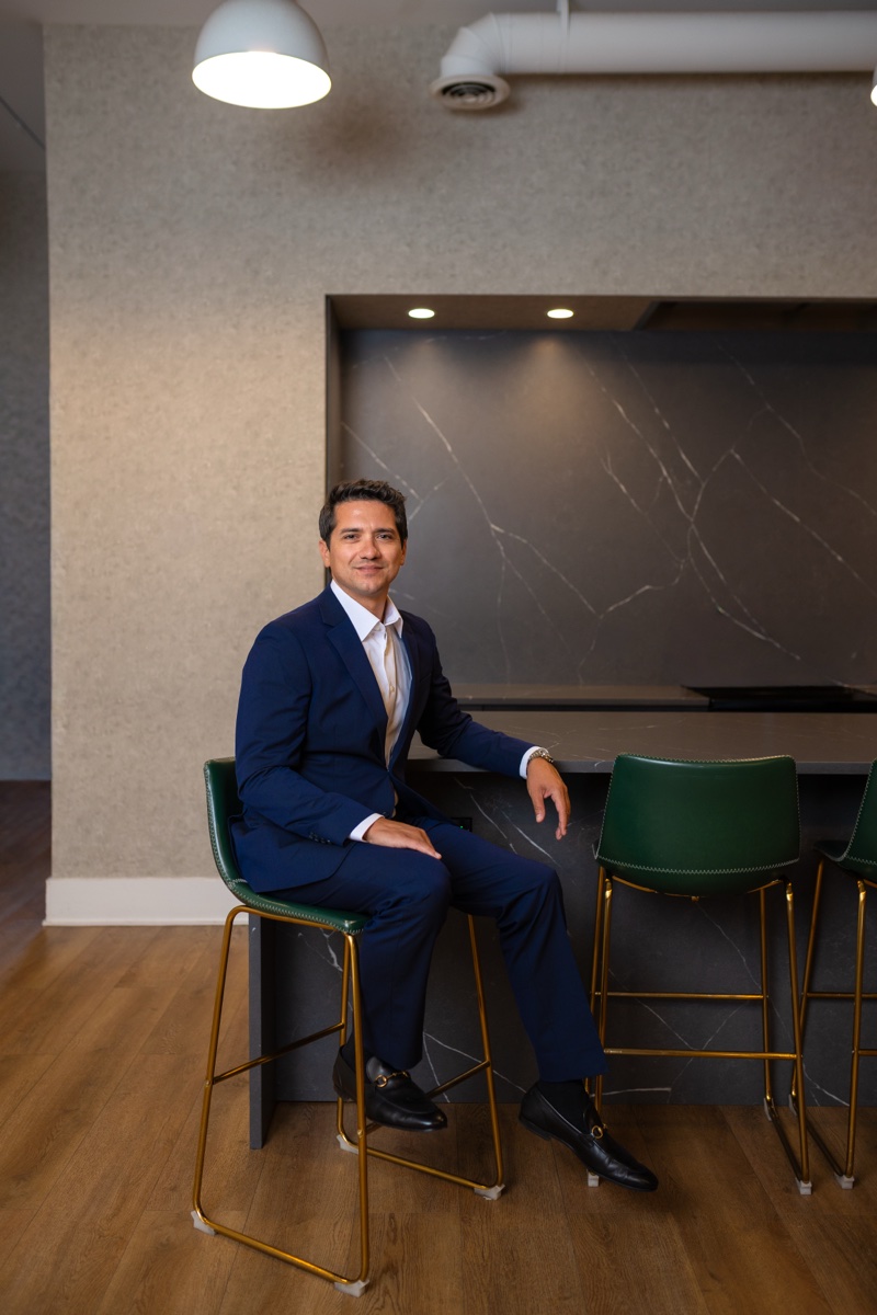 Andy Andrade, founder of Shore Properties Group, seated in a Chicago office